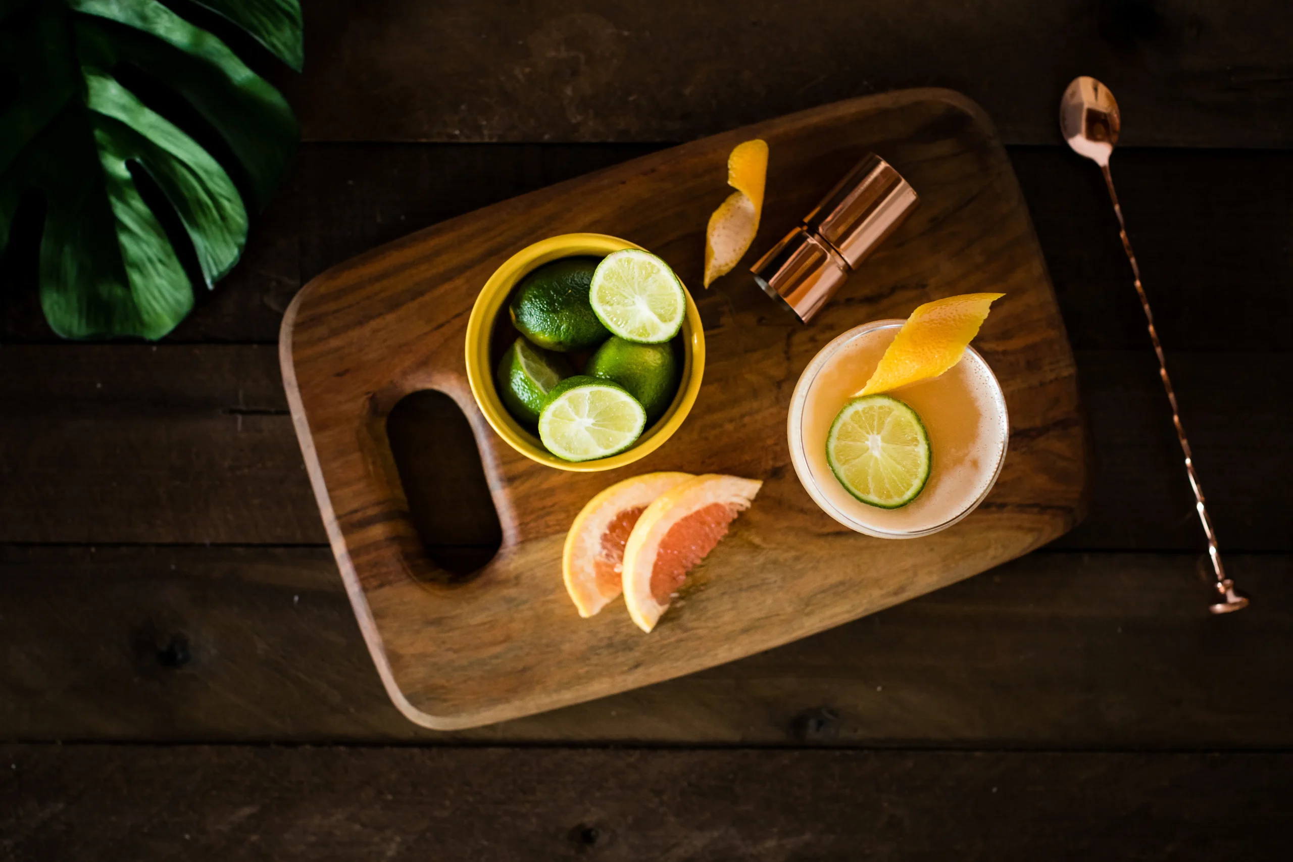 overhead view of cocktail with lemons and floral accents