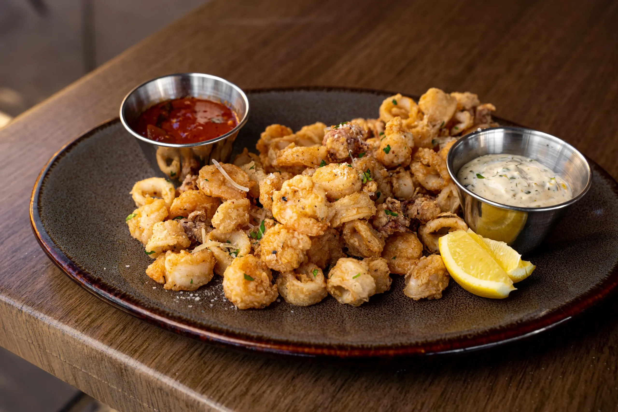 golden fried calamari with lemon garnish 