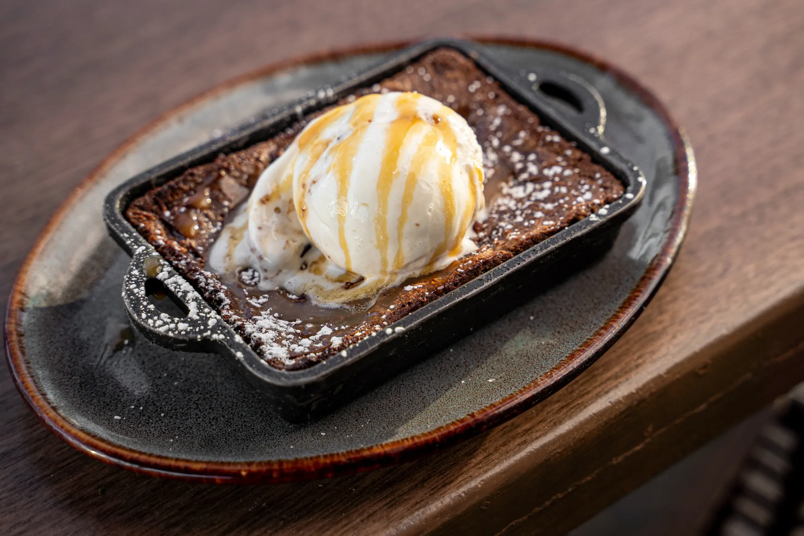 pecan fudge brownie with ice cream and caramel drizzle 